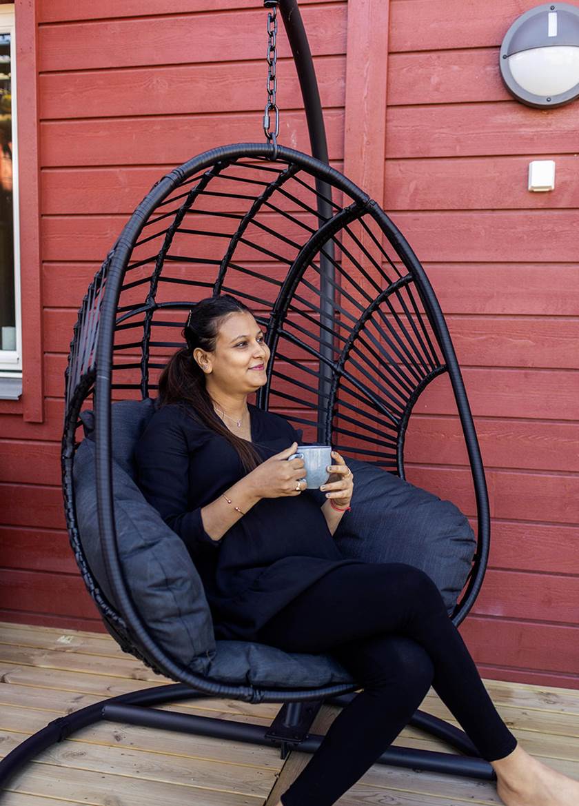 Customer sat in outdoor swing chair