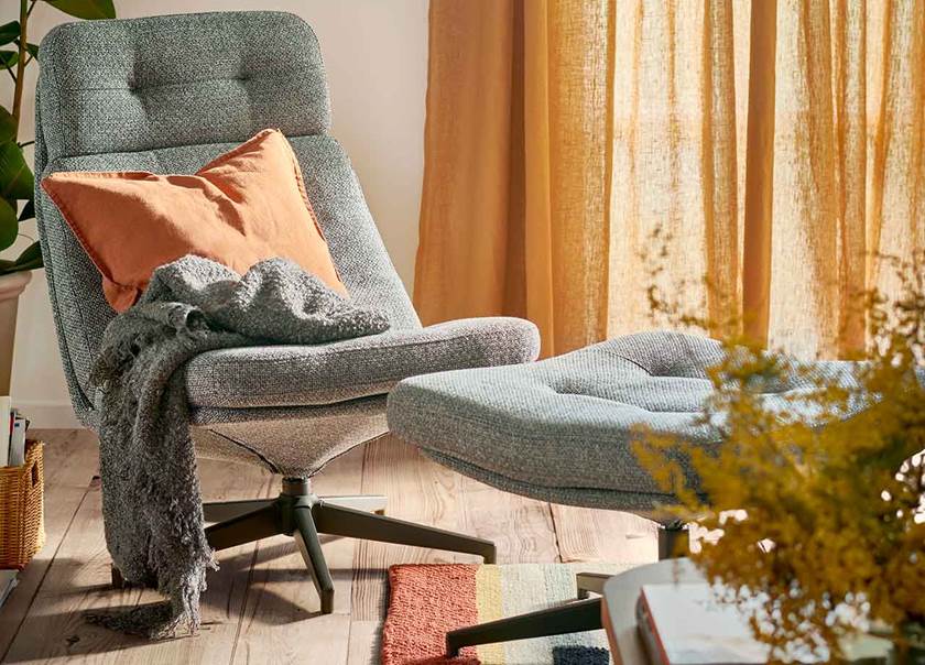 Grey chair and foot stall with orange cushion