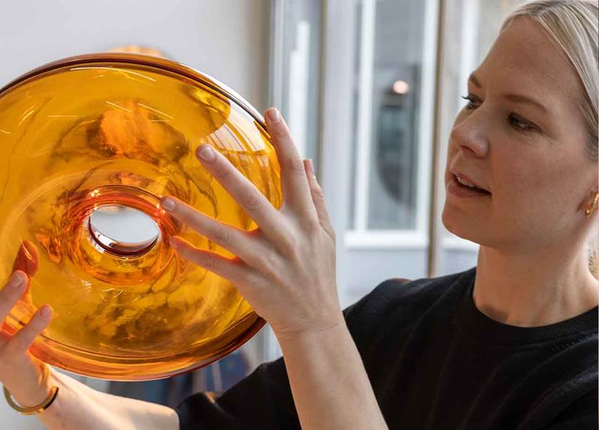 Lady holding glass orange lamp