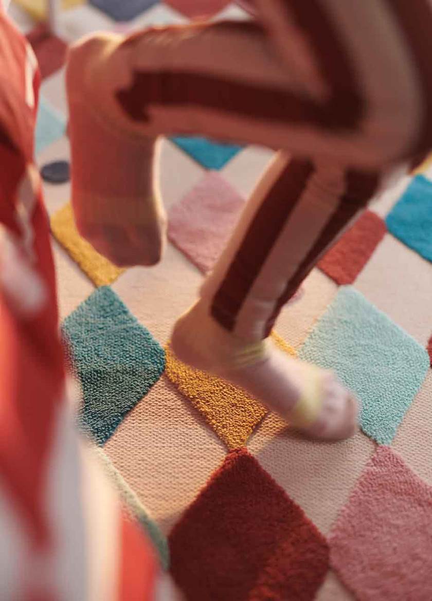 Patterned rug and child's feet