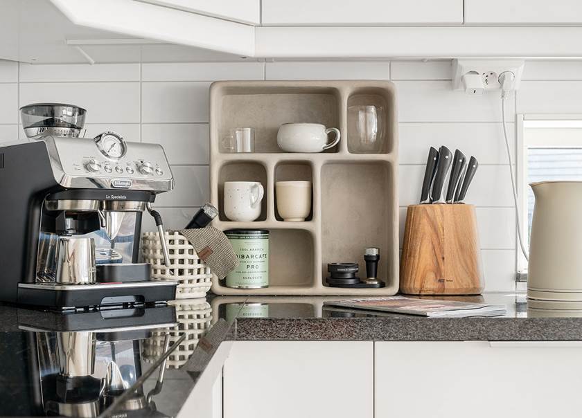 coffee machine_cups_knives_kettle_on_kitchen counter.