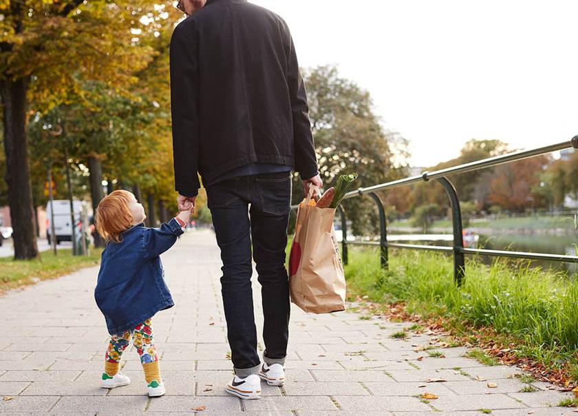 Dad on walk with daugther hand in hand. 