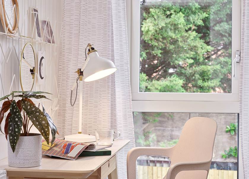 Desk with lamp and a window.