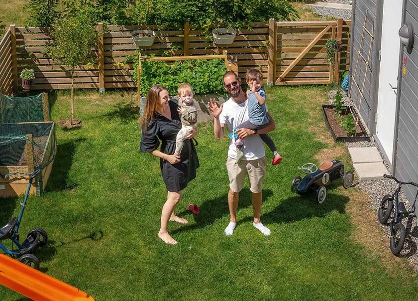 Family of four in the garden to BoKlok townhouse.