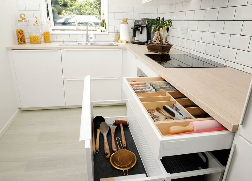 Kitchen with kitchen drawers open.