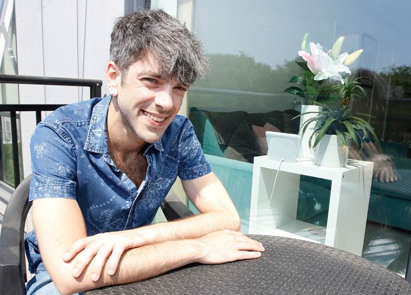 Man sat at garden table on balcony