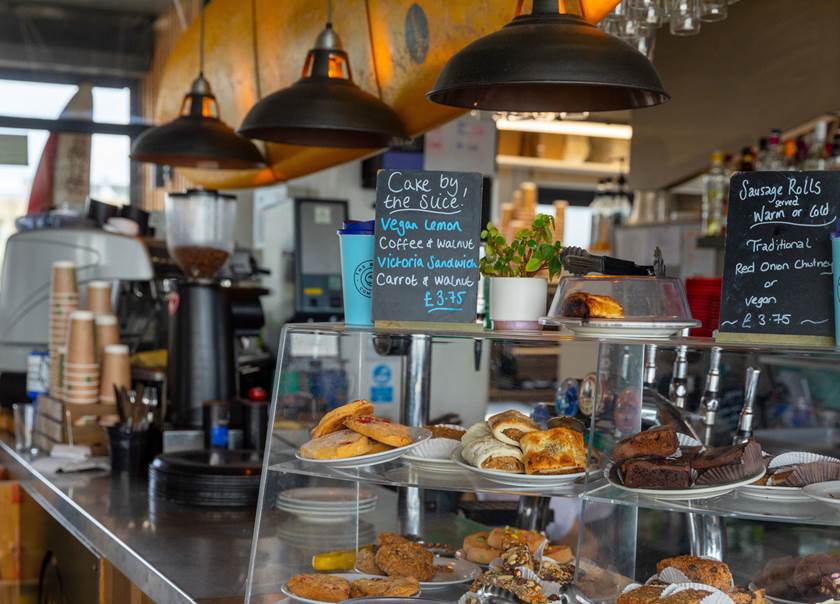 Coffee shop with glass counter with pastries.