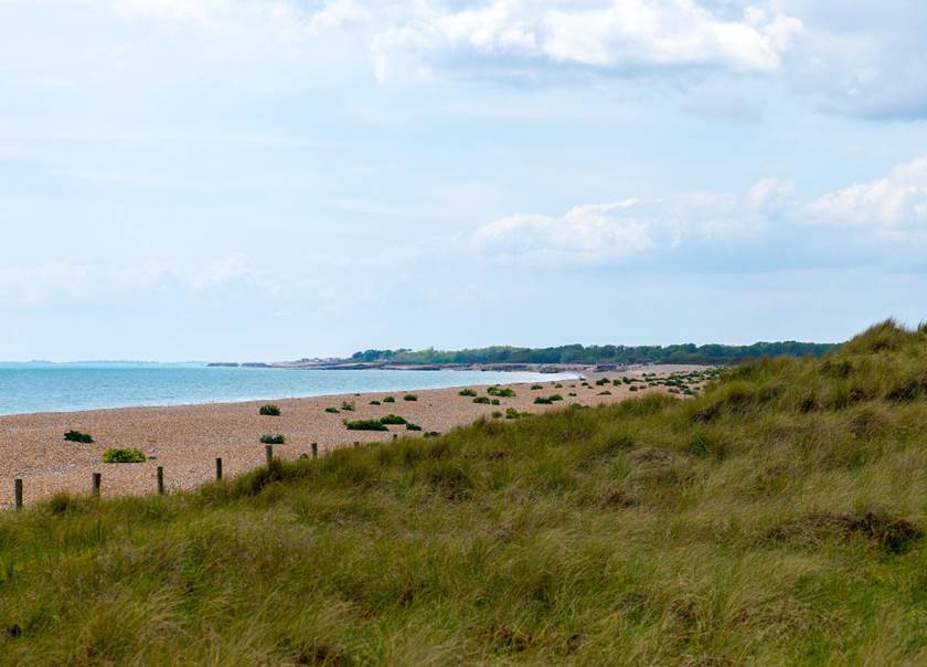 View of a beach in a slightly cloudy day.